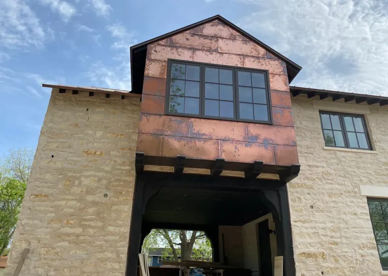 Copper metal panel facade on a stone building for Skylight Installation in Owings Mills